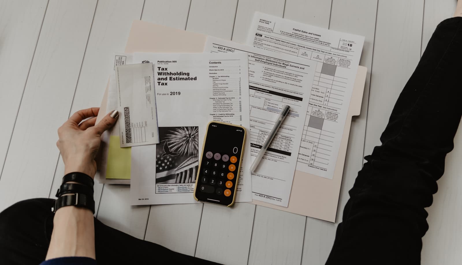 Calculator and paperwork representing fragmented operational trackers